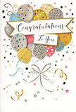 The photograph captures a refined congratulations card that radiates quiet joy, as if it were a little celebration waiting to be opened in a Hither Green living room. Dominating the front is a graceful gathering of rounded balloons clustered together, each one softly shaded in metallic gold, silver, champagne, sky blue, blush pink, and muted grey. They overlap gently, creating a sense of depth and movement, like balloons drifting just above a party table. Many of the balloons are embellished with delicate details-fine glittery stripes, tiny star patterns, and scattered specks of metallic ink-so they sparkle subtly against the pale, almost creamy background. A ribbon-like banner sweeps across the centre, carrying the words "Congratulations To You" in elegant calligraphy that feels both warm and sophisticated, the sort of message you'd send for a promotion, a new home near Mountsfield Park, or an exam success. Around the main cluster, slender ribbons curl and twist in playful lines, while golden and silvery stars and dots scatter across the surface like drifting confetti. The card appears to be printed on quality, slightly textured stock, with raised glitter that would feel just a little rough and sparkling to the touch. The mood is light and uplifting, celebrating achievement without being loud or garish. From the perspective of a local florist used to creating celebratory bouquets, this design feels like the perfect partner to fresh flowers delivered around Hither Green, offering a visual echo of pride, happiness, and well-earned congratulations.